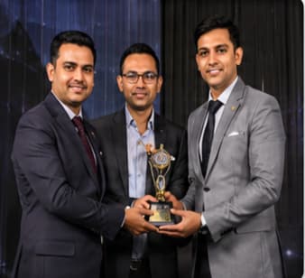 Award ceremony — recipients with trophy